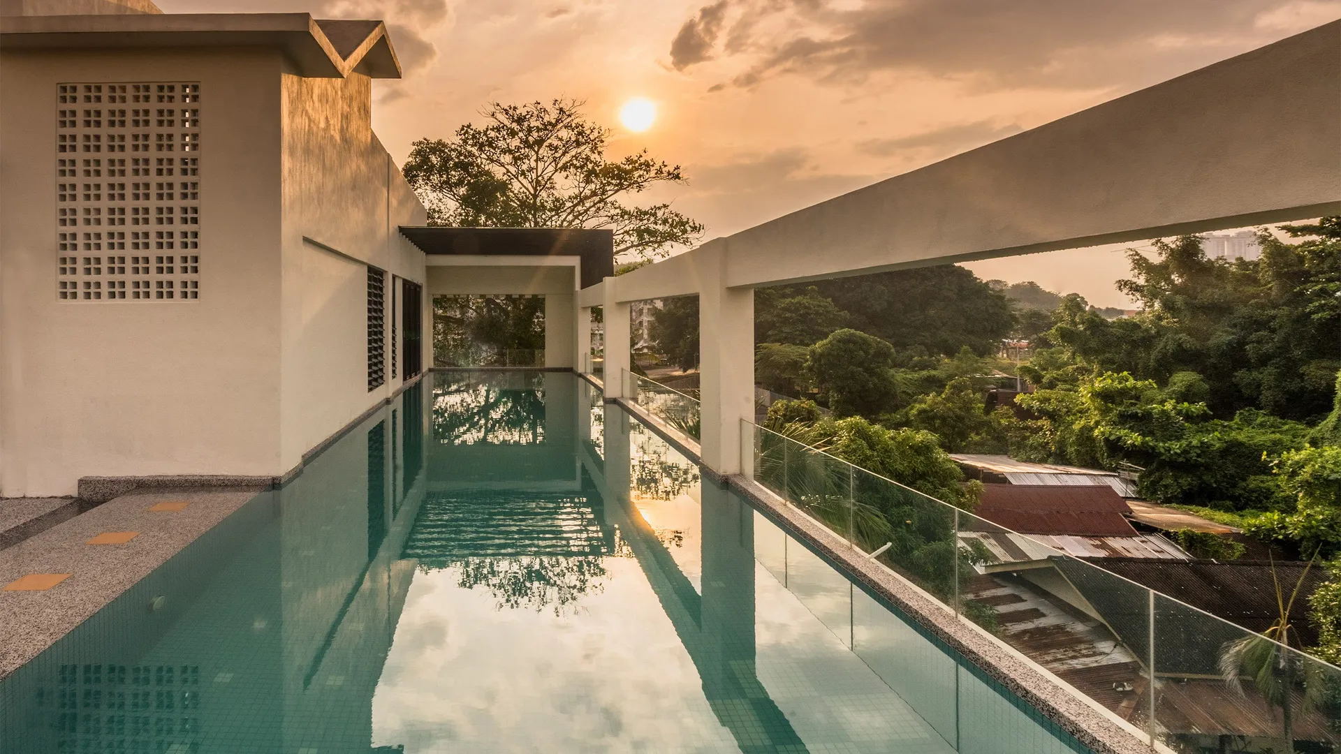 Rooftop infinity pool at sunset at Treasures Hotel & Suites Melaka